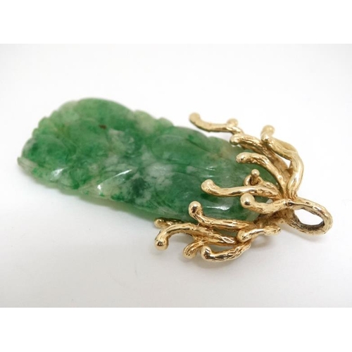 1080 - A jade pendant with 14ct gold mount. Approx 2'' long