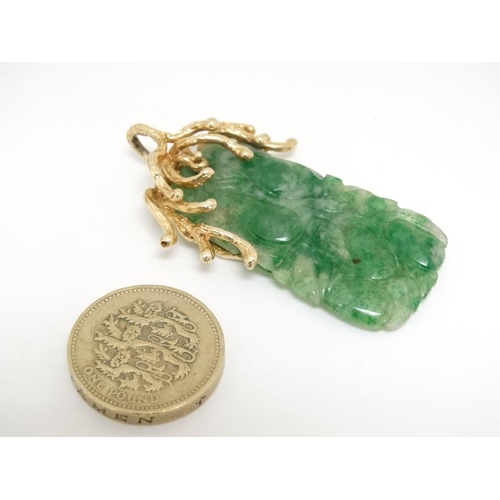 1080 - A jade pendant with 14ct gold mount. Approx 2'' long