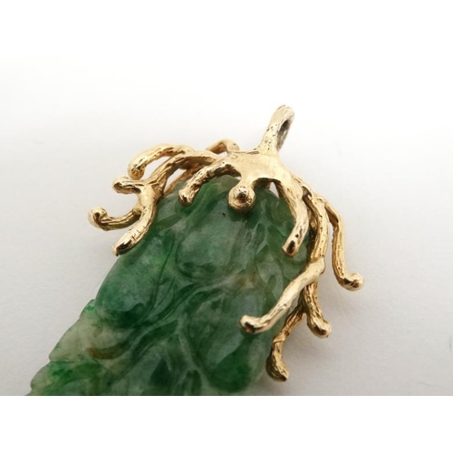 1080 - A jade pendant with 14ct gold mount. Approx 2'' long