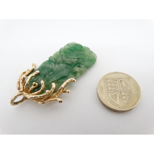 1080 - A jade pendant with 14ct gold mount. Approx 2'' long