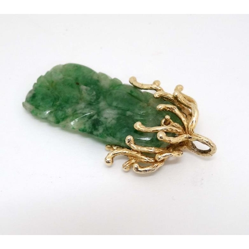 1080 - A jade pendant with 14ct gold mount. Approx 2'' long