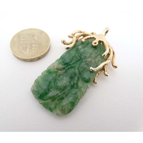 1080 - A jade pendant with 14ct gold mount. Approx 2'' long