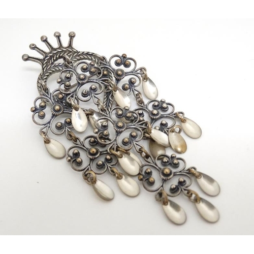 1084 - A Continental silver and white metal brooch, the central heart and crown with scroll and drop detail... 