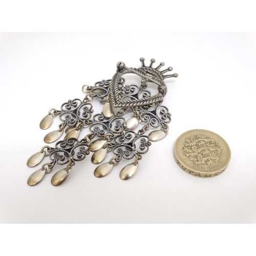 1084 - A Continental silver and white metal brooch, the central heart and crown with scroll and drop detail... 