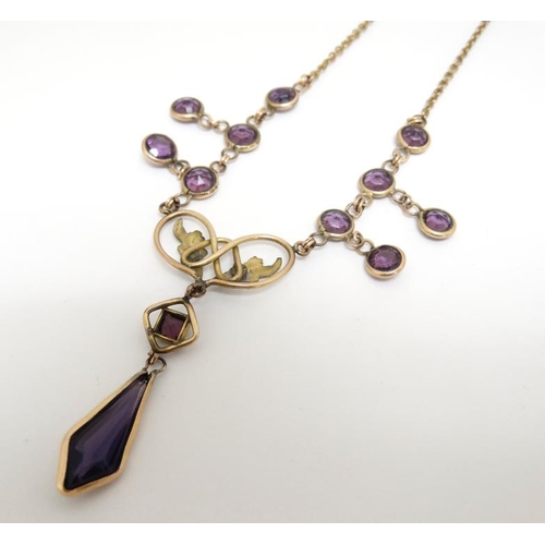 1086 - A gilt metal necklace set with facet cut amethyst coloured detail and drop . Approx 16'' long