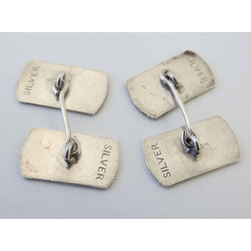 1096 - A pair of cufflinks with engine turned decoration. Marked 'silver'