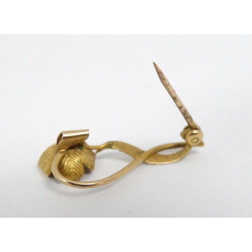 1098 - A gilt metal brooch with floral decoration set with seed pearl to flower head. 1'' long