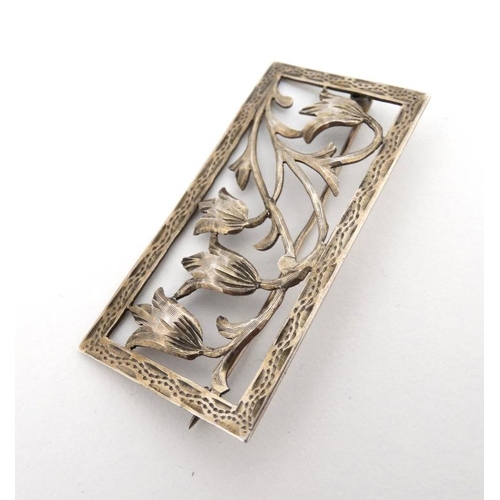 1103 - A Continental 900 silver brooch of rectangular form with floral scroll decoration 2'' x 1''