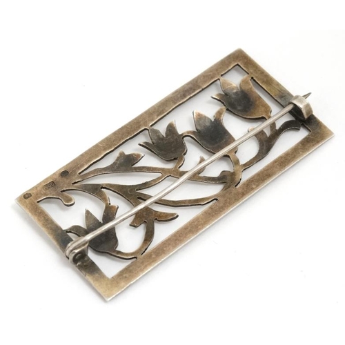 1103 - A Continental 900 silver brooch of rectangular form with floral scroll decoration 2'' x 1''