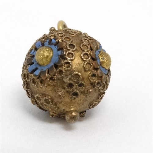 1107 - A gilt metal sphere formed pendant with enamel decoration. Approx ½'' diameter