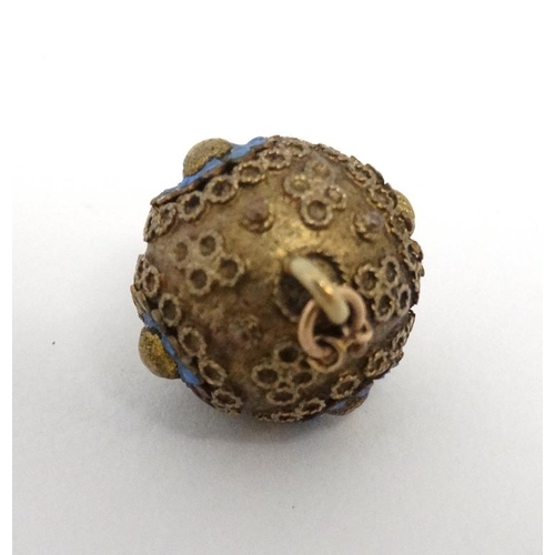 1107 - A gilt metal sphere formed pendant with enamel decoration. Approx ½'' diameter