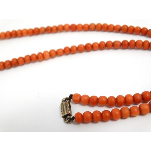 1109 - An early 20thC necklace of graduated coral beads. Approx 20'' long