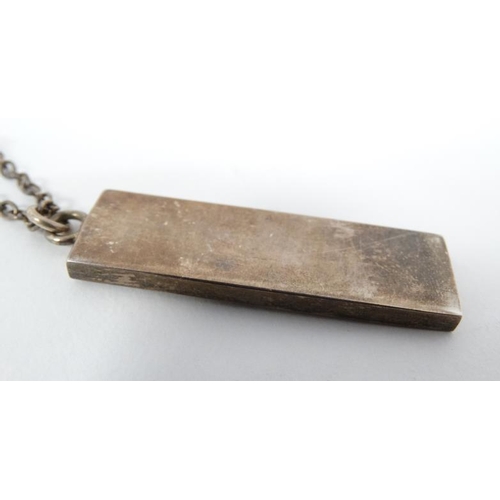 1112 - A silver chain with silver pendant of ingot form hallmarked London 1977 with jubilee mark. The penda... 