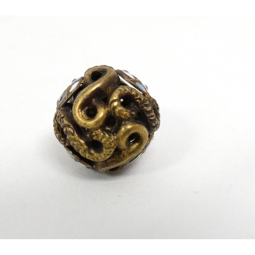 1113 - A gilt metal pendant of spherical form with enamel decoration. Approx  ½'' diameter