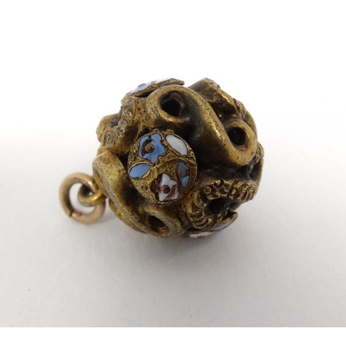 1113 - A gilt metal pendant of spherical form with enamel decoration. Approx  ½'' diameter