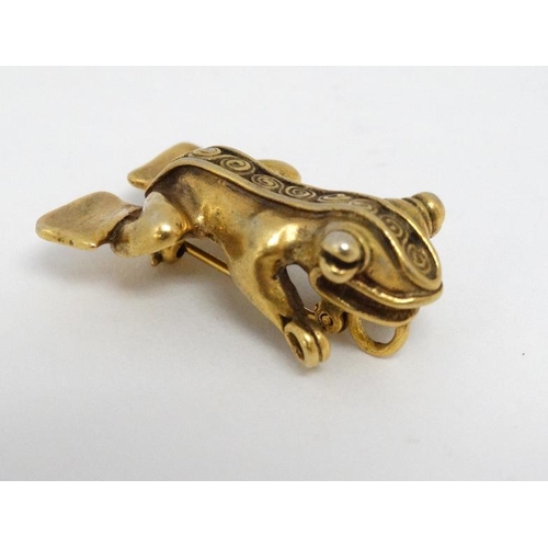 1114 - A gilt metal brooch formed as a stylised frog. Marked MMA 1 ¼''