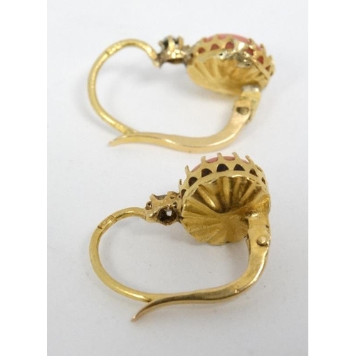 1115 - A pair of gilt metal drop earrings set with coral cabochon and white stones.