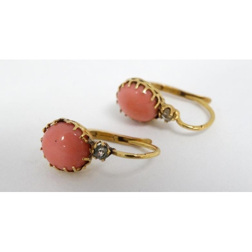 1115 - A pair of gilt metal drop earrings set with coral cabochon and white stones.