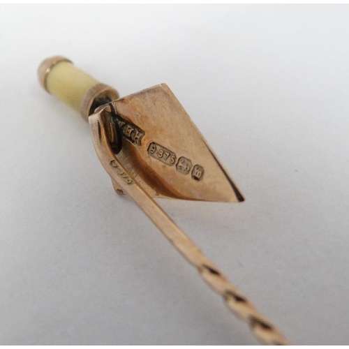 1118 - A 9ct gold stick pin surmounted by a 9ct gold miniature trowel.  The whole 2 ½'' long