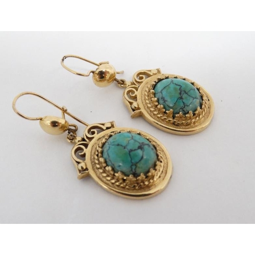 1121 - A pair of gilt metal drop earrings set with turquoise hardstone cabochon Approx 1 ½'' long