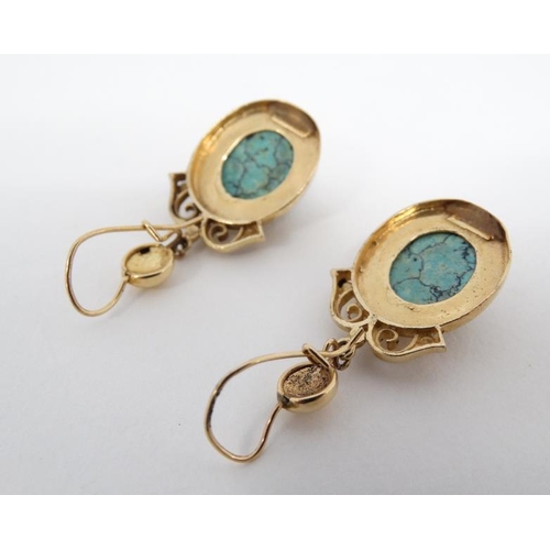 1121 - A pair of gilt metal drop earrings set with turquoise hardstone cabochon Approx 1 ½'' long