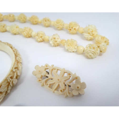 1123 - A 19thC Cantonese carved ivory bangle together with a bead necklace  (2)