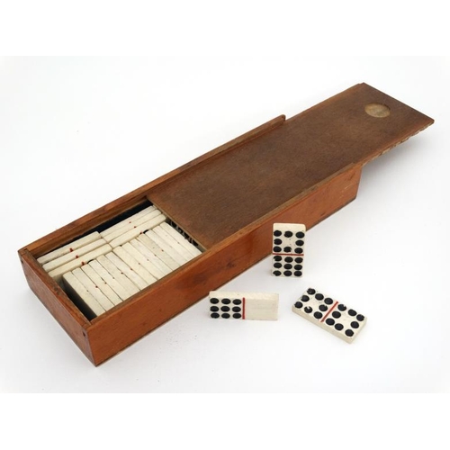 1158 - Militaria : An early 19thC boxed part double set of carved bone Dominoes , Napoleonic POW - made , e... 