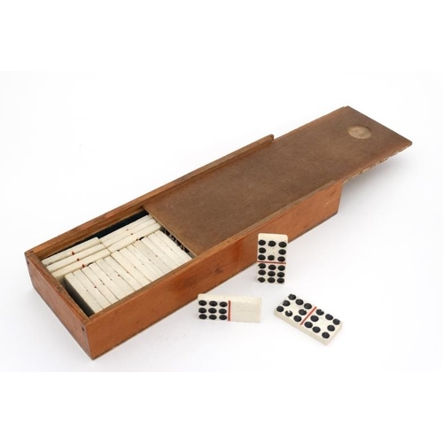 1158 - Militaria : An early 19thC boxed part double set of carved bone Dominoes , Napoleonic POW - made , e... 