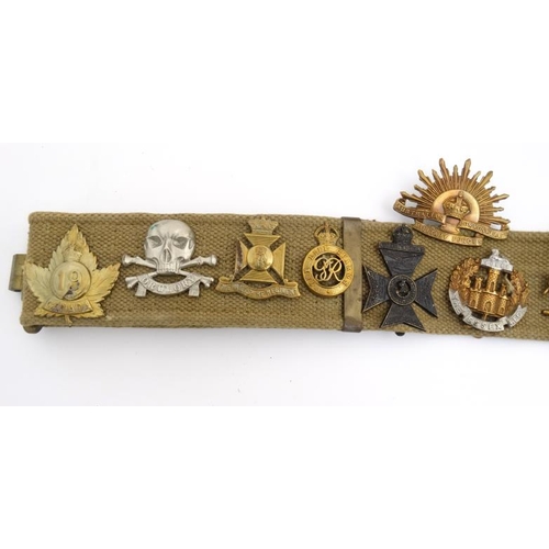 1159 - Militaria : A WWII webbing belt having applied cap badges of the 17th/21st Lancers , the Life Guards... 