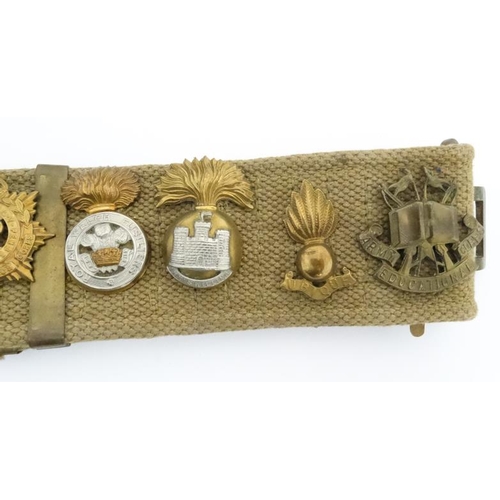 1159 - Militaria : A WWII webbing belt having applied cap badges of the 17th/21st Lancers , the Life Guards... 