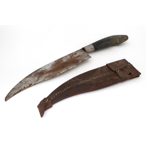 1169 - Militaria : A 19thC Eastern large fighting knife , the 10 3/4'' curved and swept steel blade having ... 