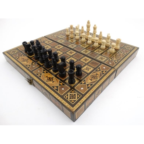 1183 - A mid 20thC Damascus folding chess and backgammon board with decorative wooden and mother of pearl m... 