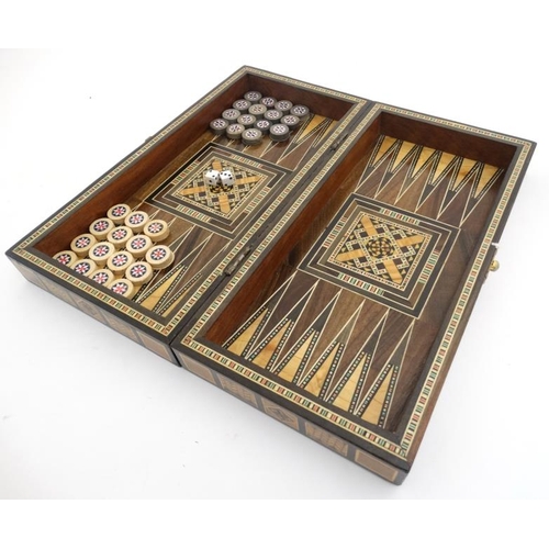 1183 - A mid 20thC Damascus folding chess and backgammon board with decorative wooden and mother of pearl m... 