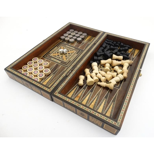 1183 - A mid 20thC Damascus folding chess and backgammon board with decorative wooden and mother of pearl m... 