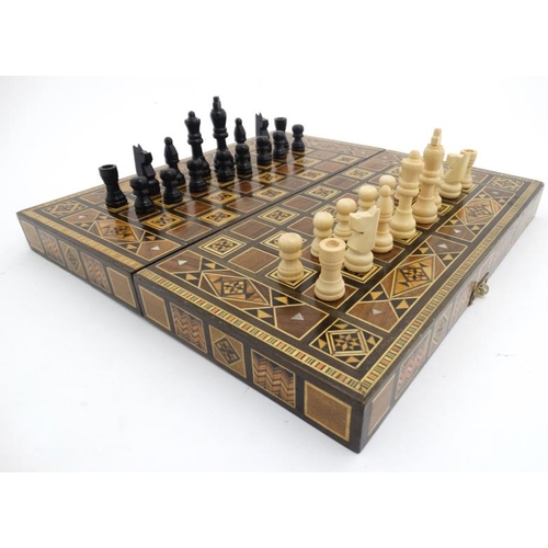 1183 - A mid 20thC Damascus folding chess and backgammon board with decorative wooden and mother of pearl m... 