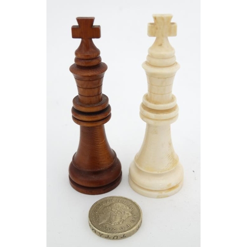 1184 - An early 20thC carved and stained brown and white ivory Staunton style chess set. The kings 3'' high... 