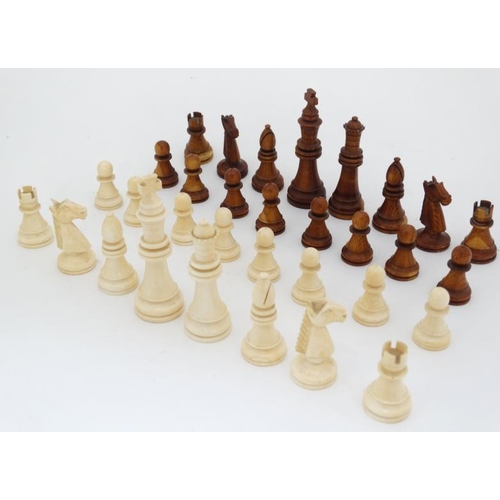 1184 - An early 20thC carved and stained brown and white ivory Staunton style chess set. The kings 3'' high... 