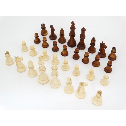 1184 - An early 20thC carved and stained brown and white ivory Staunton style chess set. The kings 3'' high... 