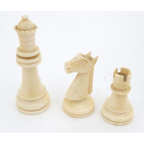 1184 - An early 20thC carved and stained brown and white ivory Staunton style chess set. The kings 3'' high... 