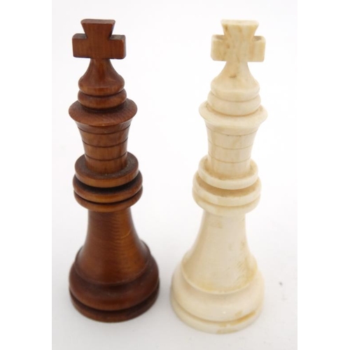 1184 - An early 20thC carved and stained brown and white ivory Staunton style chess set. The kings 3'' high... 