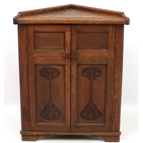 179 - Arts and crafts / Art Nouveau : A late 19thC stained oak 2-door floor standing corner cabinet 35'' h... 