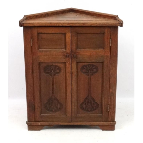 179 - Arts and crafts / Art Nouveau : A late 19thC stained oak 2-door floor standing corner cabinet 35'' h... 