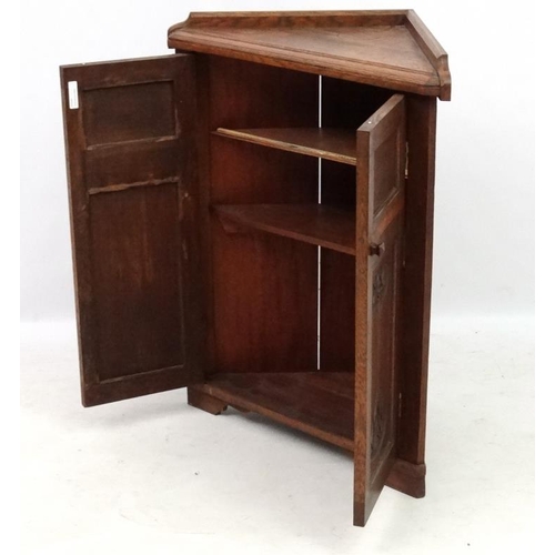 179 - Arts and crafts / Art Nouveau : A late 19thC stained oak 2-door floor standing corner cabinet 35'' h... 