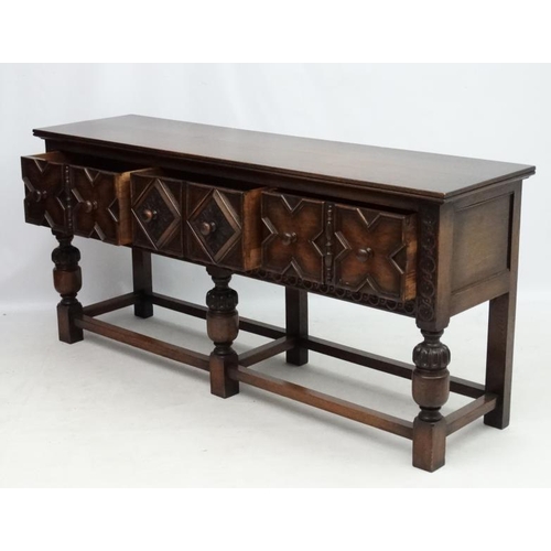 199 - Maple and Co , a 1920's oak Jacobean sideboard with three drawers, 72'' long x 33'' high x 18 3/4'' ... 