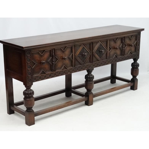 199 - Maple and Co , a 1920's oak Jacobean sideboard with three drawers, 72'' long x 33'' high x 18 3/4'' ... 