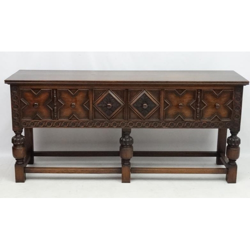 199 - Maple and Co , a 1920's oak Jacobean sideboard with three drawers, 72'' long x 33'' high x 18 3/4'' ... 