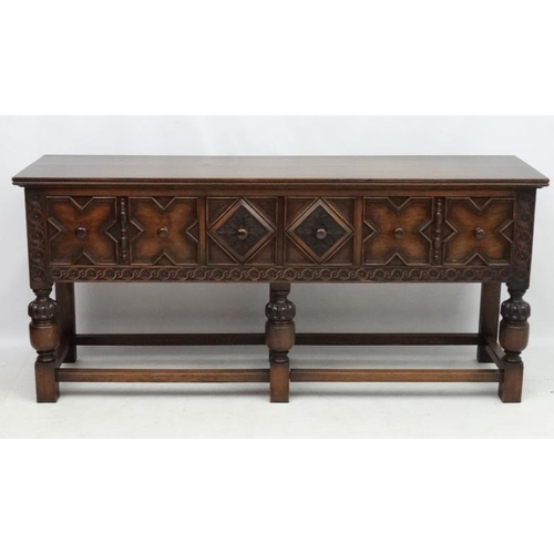 199 - Maple and Co , a 1920's oak Jacobean sideboard with three drawers, 72'' long x 33'' high x 18 3/4'' ... 