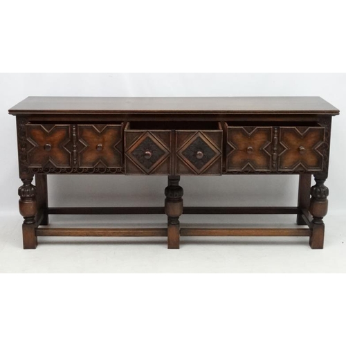 199 - Maple and Co , a 1920's oak Jacobean sideboard with three drawers, 72'' long x 33'' high x 18 3/4'' ... 