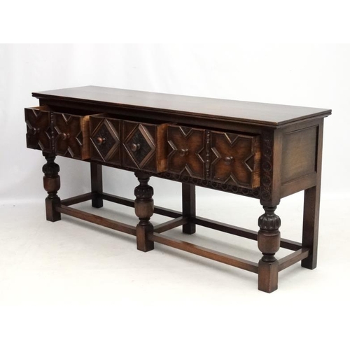 199 - Maple and Co , a 1920's oak Jacobean sideboard with three drawers, 72'' long x 33'' high x 18 3/4'' ... 