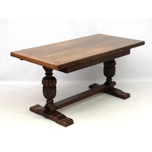 200 - An oak Jacobean style drawer leaf table and cup and cover trestle ends 30'' wide x 60 1/2'' (unexten... 